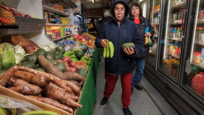 image of Camden resident holding produce in a store