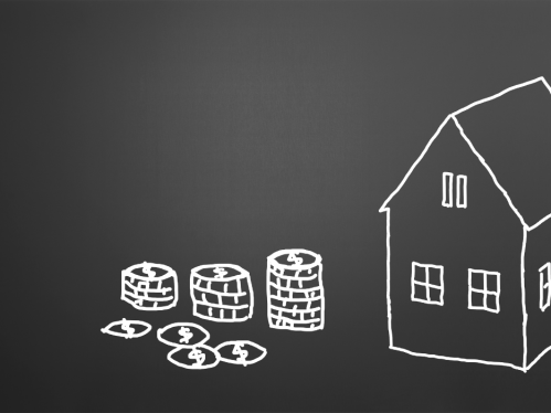 Image of a stack of money next to a house